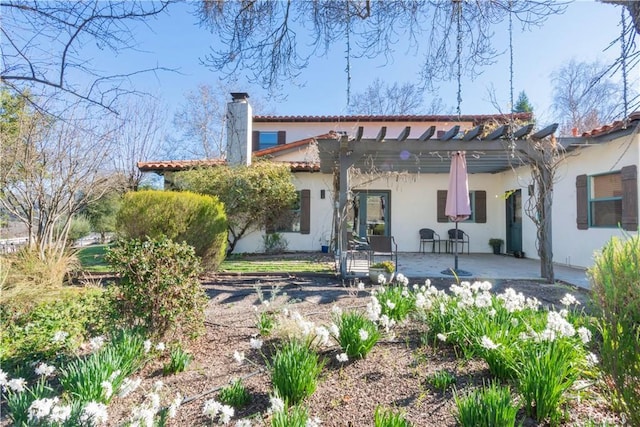 rear view of property with a pergola and a patio