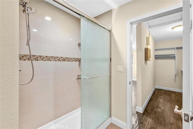 bathroom with hardwood / wood-style floors and an enclosed shower