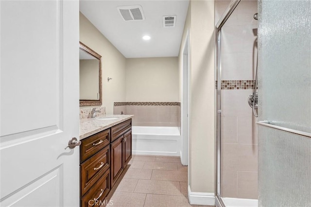 bathroom featuring vanity, tile patterned flooring, and plus walk in shower