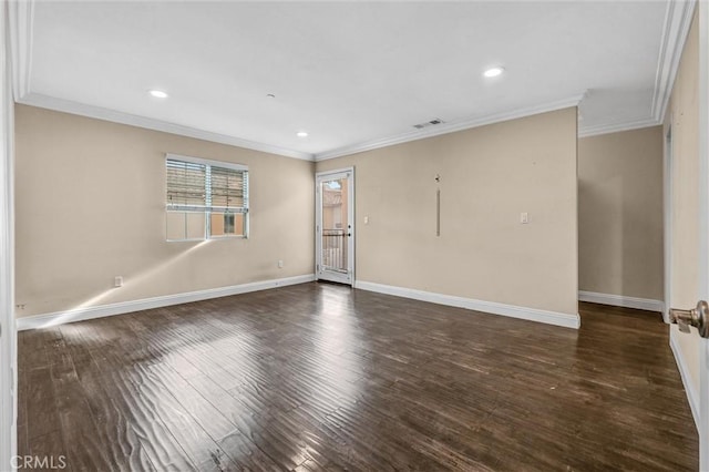 spare room with ornamental molding and dark hardwood / wood-style flooring