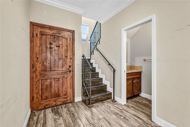 entrance foyer with crown molding and light wood-type flooring