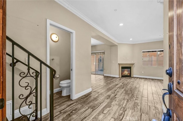 interior space with hardwood / wood-style flooring and ornamental molding