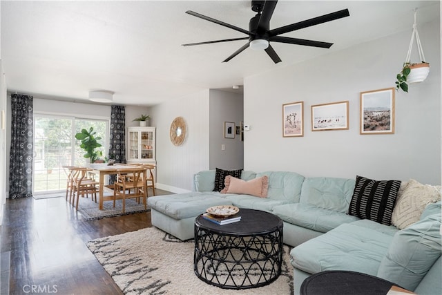 living room featuring dark hardwood / wood-style flooring and ceiling fan