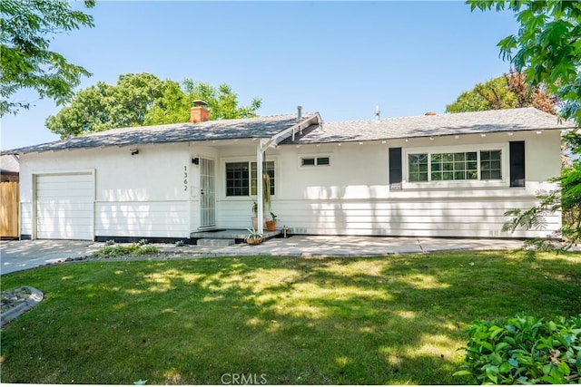 view of front of house with a garage and a front yard