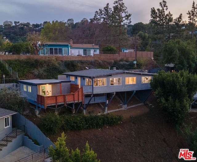 view of back house at dusk