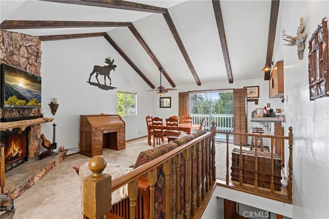 carpeted living room featuring a fireplace, high vaulted ceiling, beam ceiling, and a wealth of natural light