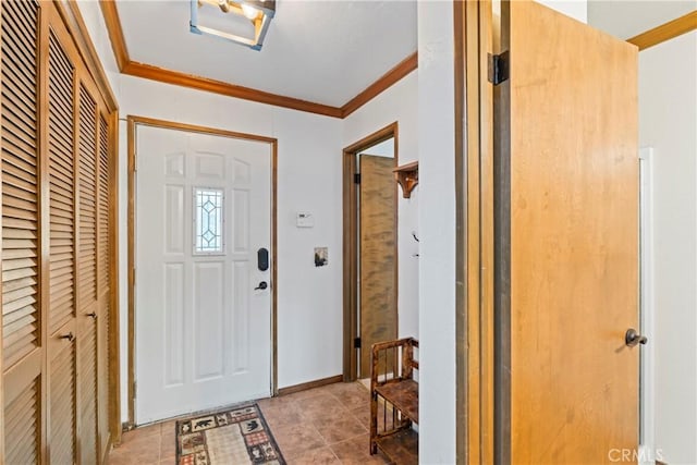 entryway with crown molding and light tile patterned flooring