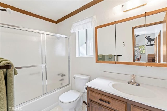 full bathroom with a healthy amount of sunlight, vanity, toilet, and combined bath / shower with glass door