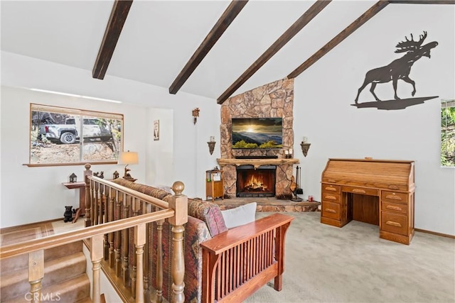 carpeted living room with beam ceiling, a stone fireplace, and high vaulted ceiling