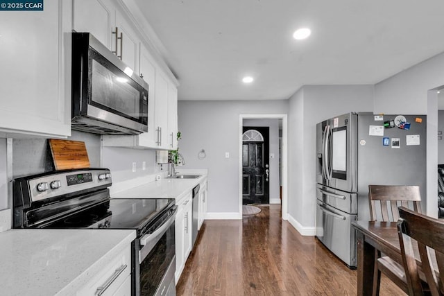 kitchen with white cabinetry, stainless steel appliances, dark hardwood / wood-style floors, and sink