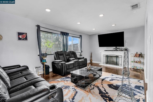 living room featuring hardwood / wood-style flooring and a fireplace