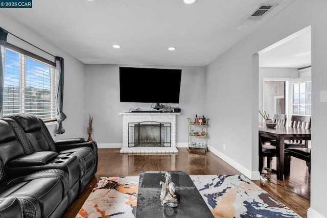 living room featuring a fireplace and dark hardwood / wood-style floors