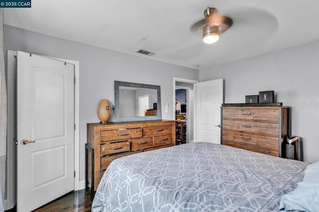 bedroom with ceiling fan and dark hardwood / wood-style flooring