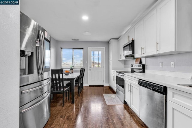 kitchen featuring white cabinetry, stainless steel appliances, and dark hardwood / wood-style flooring