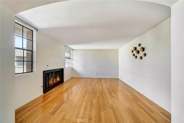 unfurnished living room featuring wood-type flooring