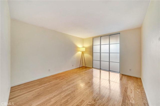 spare room featuring light hardwood / wood-style floors