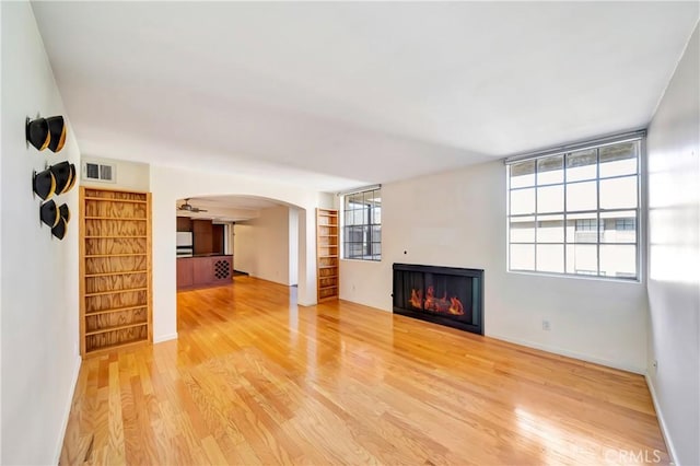 unfurnished living room featuring hardwood / wood-style floors and a wealth of natural light