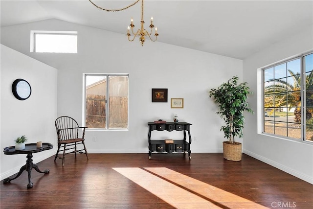 sitting room with lofted ceiling, dark hardwood / wood-style flooring, and a chandelier