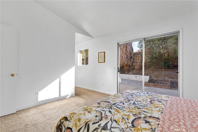 bedroom with vaulted ceiling, carpet, and access to outside