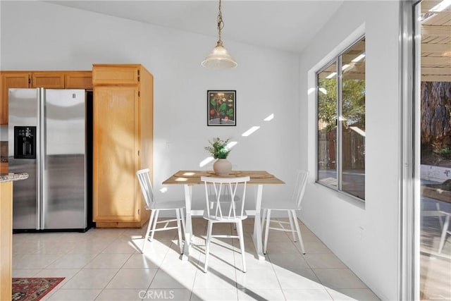 tiled dining room with lofted ceiling