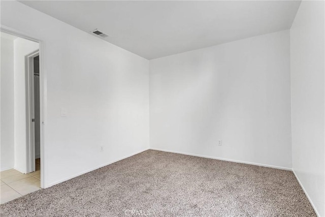 unfurnished room with light colored carpet