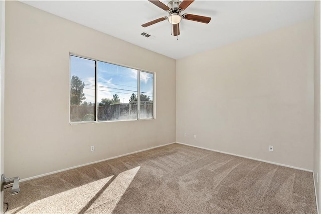 carpeted empty room featuring ceiling fan