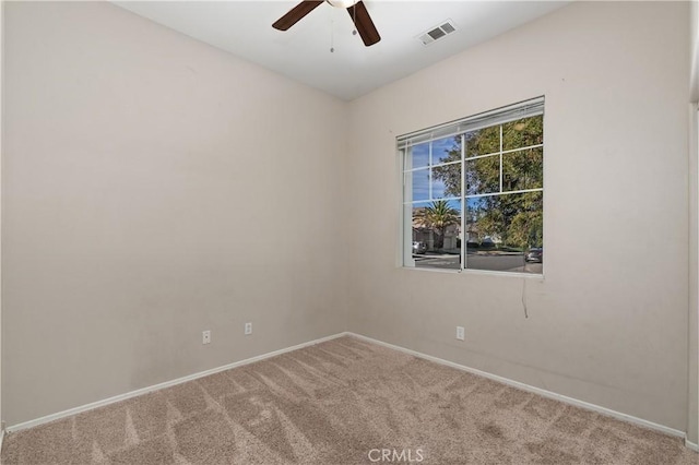 empty room featuring ceiling fan and carpet flooring