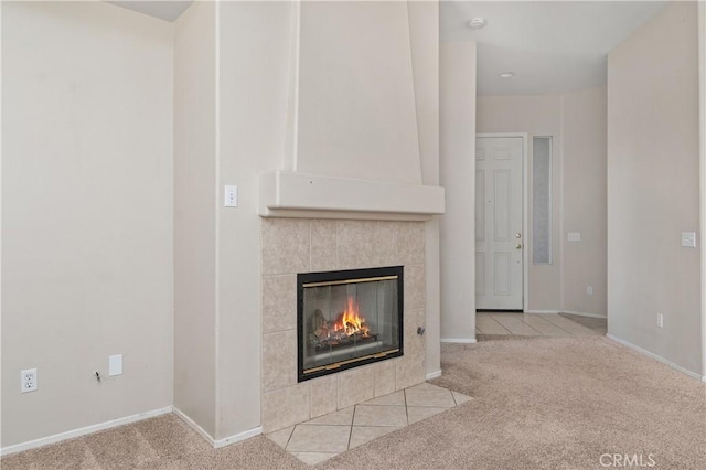 room details featuring carpet flooring and a tile fireplace