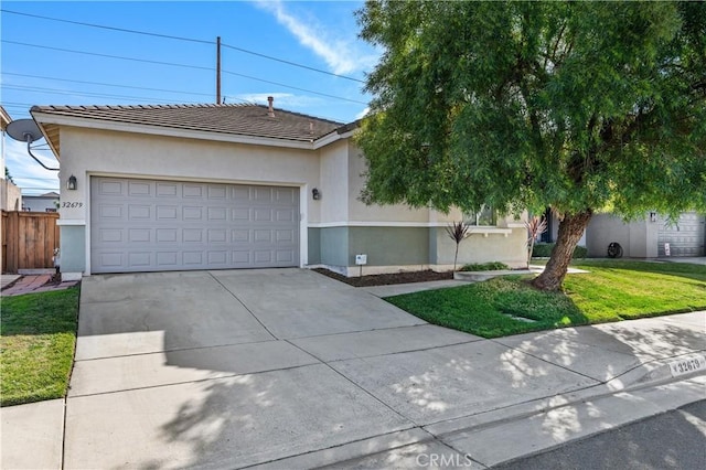 single story home with a garage and a front lawn