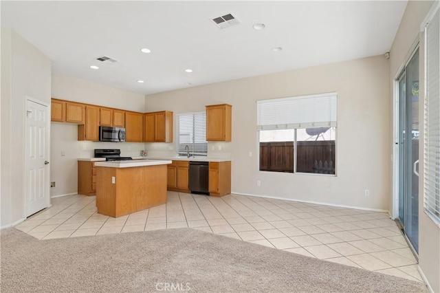 kitchen featuring light tile patterned floors, sink, electric range oven, black dishwasher, and a kitchen island