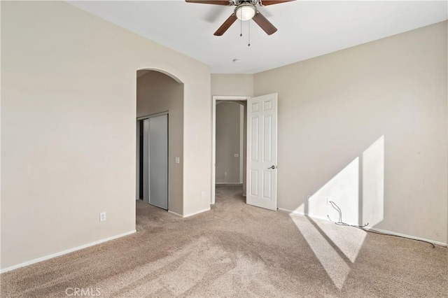 spare room featuring ceiling fan and light carpet