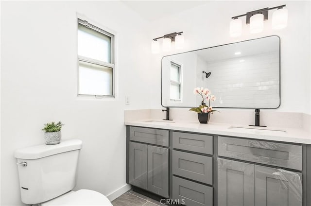 bathroom featuring vanity, tile patterned floors, and toilet