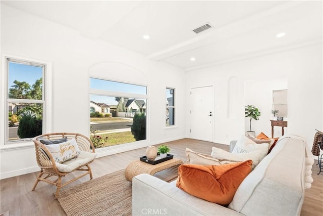 living room with beam ceiling and light hardwood / wood-style floors