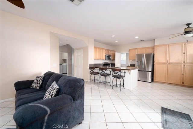 tiled living room featuring ceiling fan