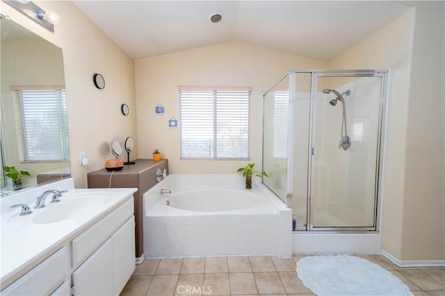 bathroom with tile patterned flooring, vanity, separate shower and tub, and vaulted ceiling