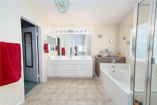 bathroom with tile patterned flooring, vanity, and shower with separate bathtub