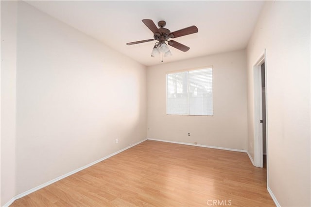 spare room with ceiling fan and light wood-type flooring