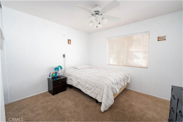 bedroom with ceiling fan and light carpet