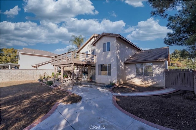 view of front of property with a deck and a patio area