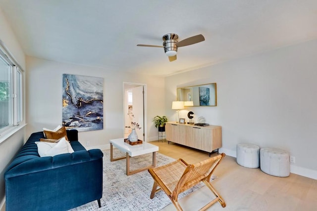 living room featuring light hardwood / wood-style flooring and ceiling fan