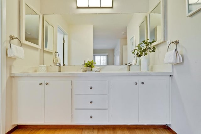 bathroom with vanity and hardwood / wood-style floors