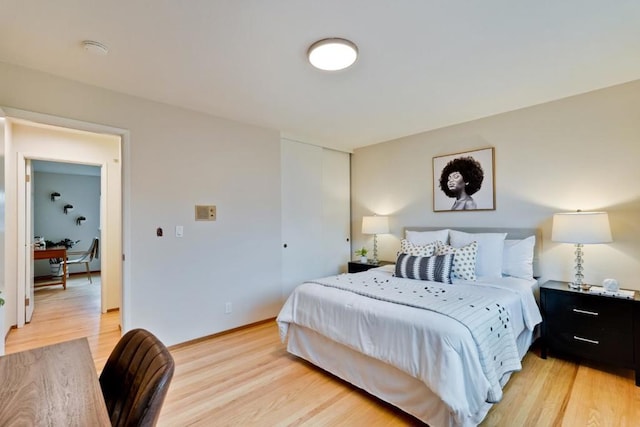 bedroom featuring a closet and light hardwood / wood-style flooring