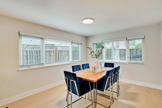 dining space featuring light wood-type flooring