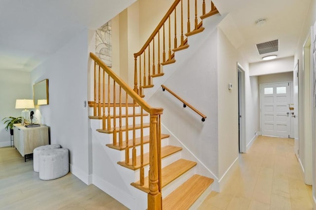 staircase featuring wood-type flooring