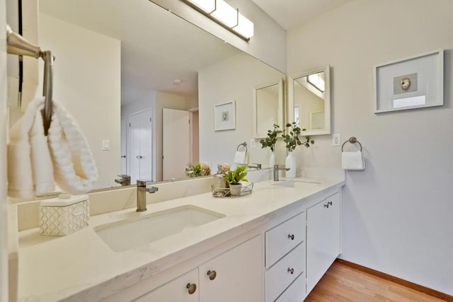 bathroom with vanity and hardwood / wood-style flooring