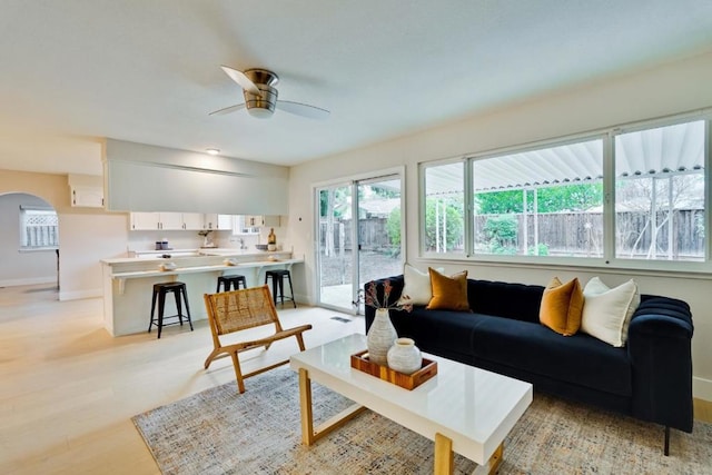 living room featuring light wood-type flooring and ceiling fan