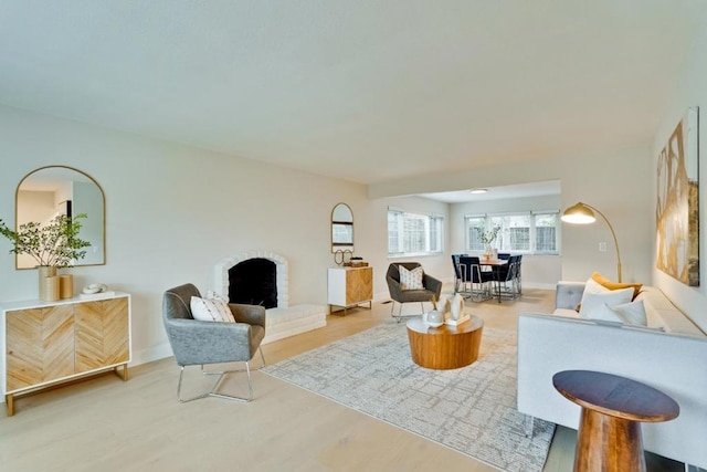 living room with hardwood / wood-style flooring and a fireplace