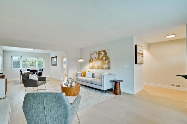 living room with light hardwood / wood-style flooring