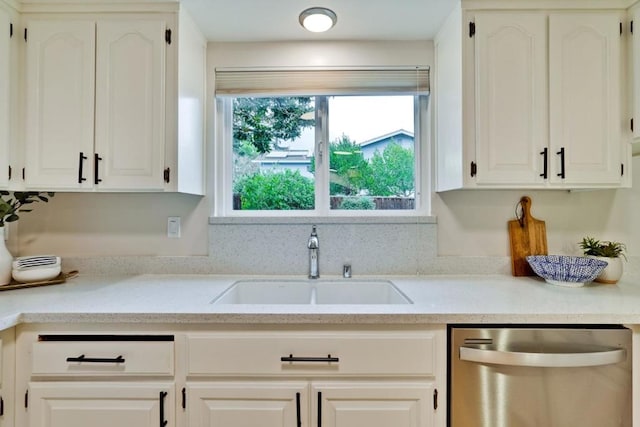 kitchen with sink, stainless steel dishwasher, and white cabinets