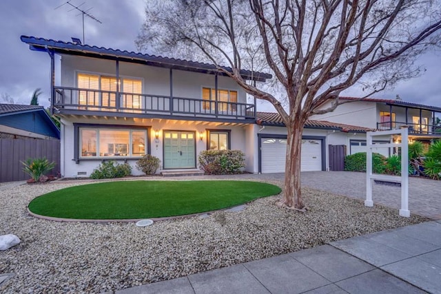 view of front of house with a front yard and a balcony